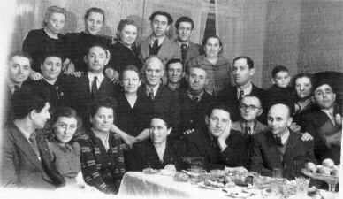 Another photograph of Belchatow survivors at a meal.